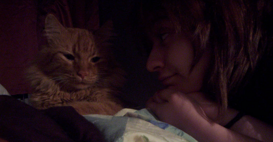 woman smiling with her cat