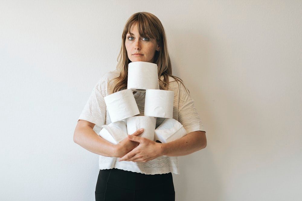 Woman holding multiple toilet papers