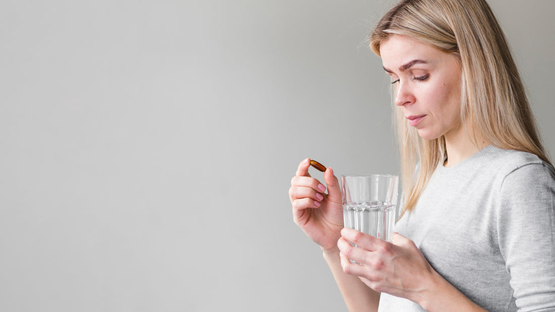 woman with pill and a glass of water