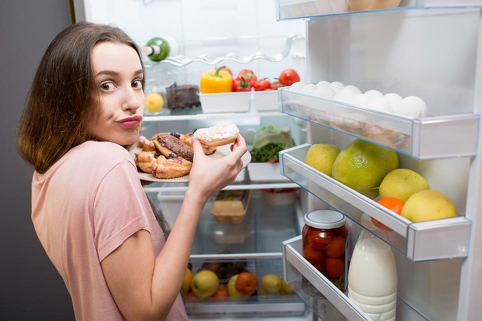 Woman who is in front of a freezer looking at the camera