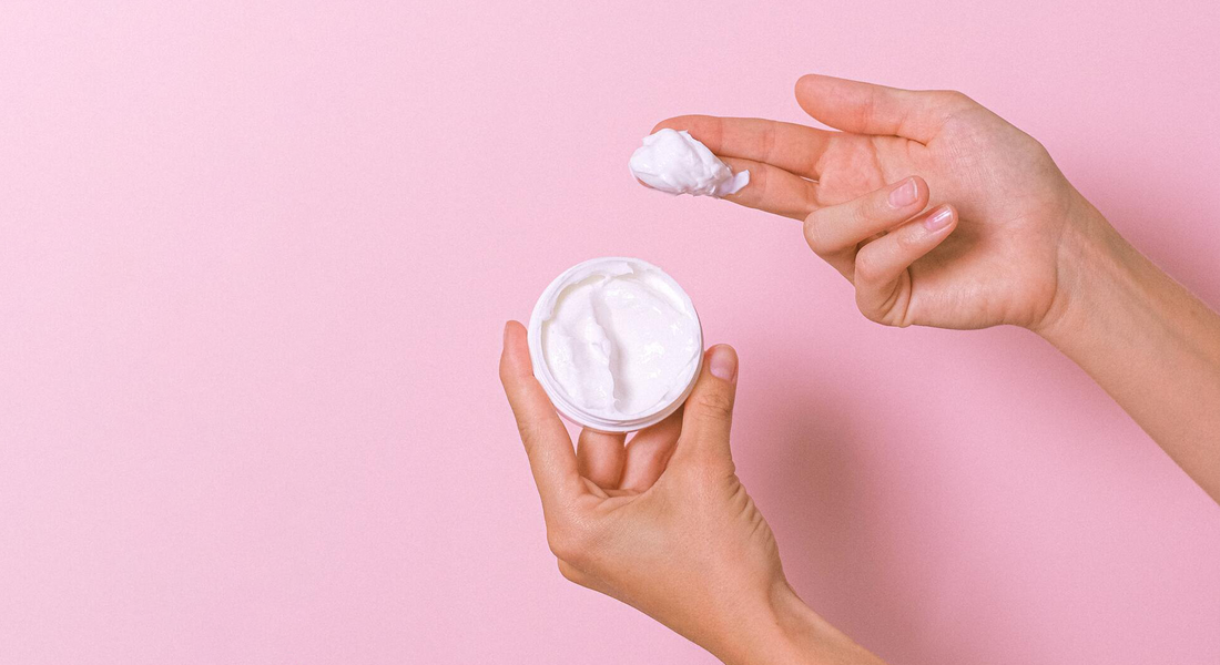 hands of a woman holding a face cream