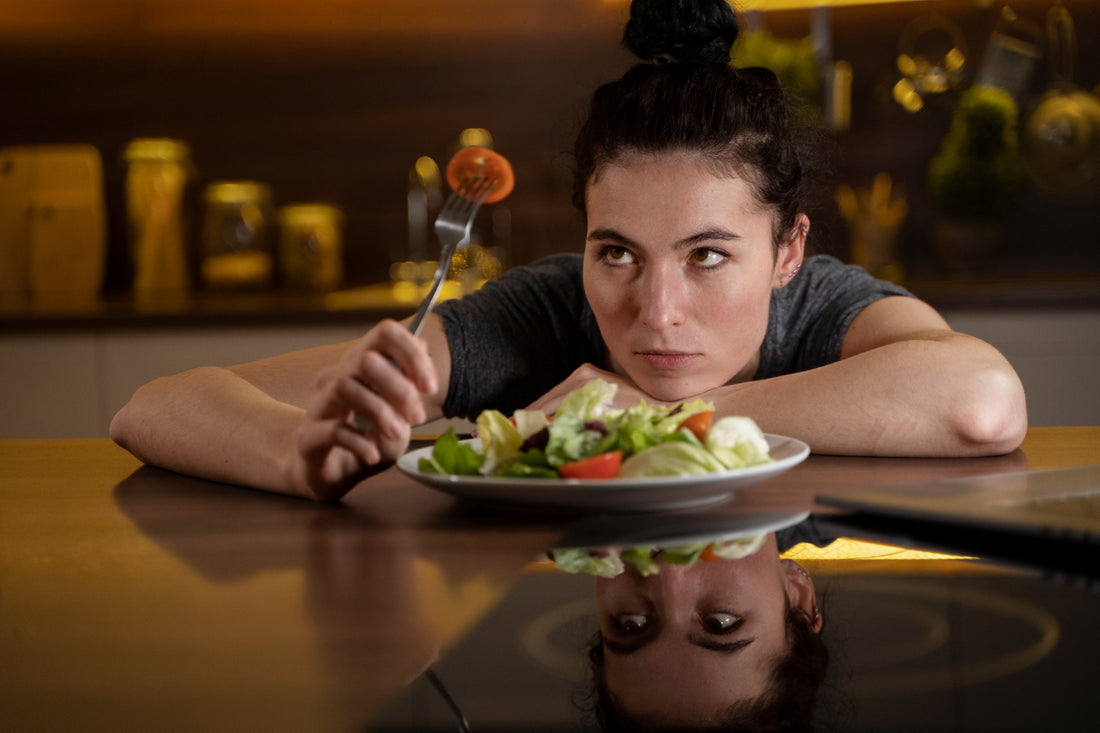 woman looking at a fork on her hand